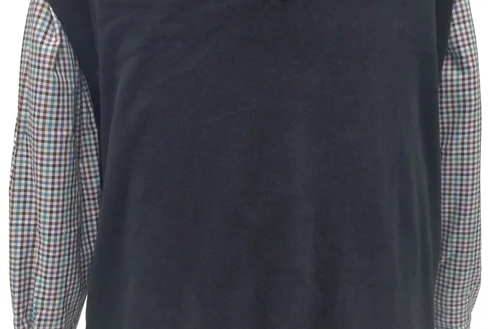 Back view of a person wearing a black shirt with plaid sleeves.