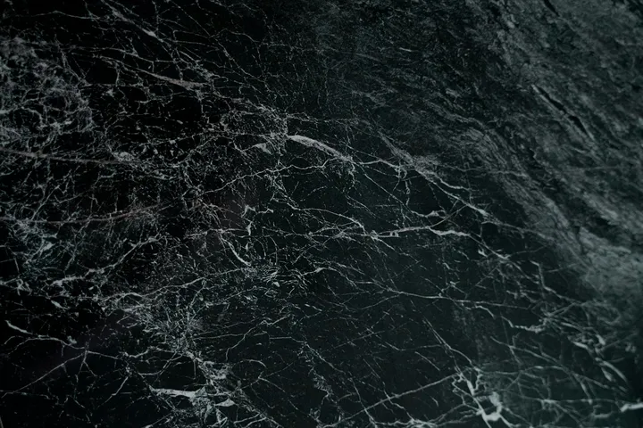 Close-up of a dark, veined stone surface resembling marble or granite.