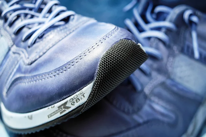 Close-up of blue athletic sneakers emphasizing the toe area