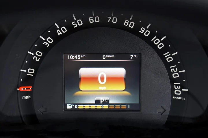 Close-up of a car dashboard with a center display showing 0 mph, time 10:45 am, and 7°C, indicating the vehicle is stationary.