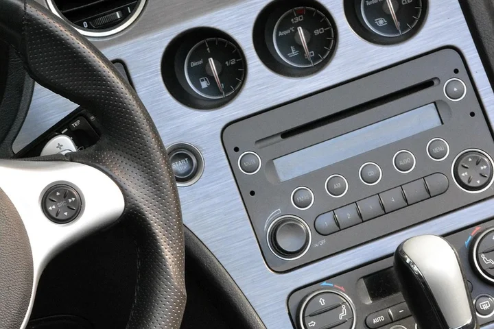 Close-up of a car dashboard with steering wheel and stereo controls