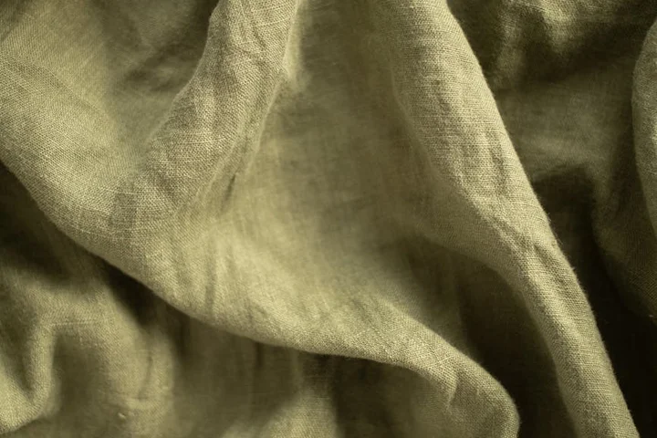Close-up of beige, textured fabric with soft folds