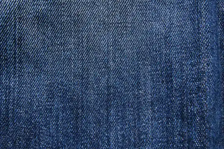 Close-up of blue denim fabric showing a diagonal weave