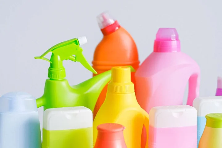 Assorted colorful plastic cleaning bottles arranged together