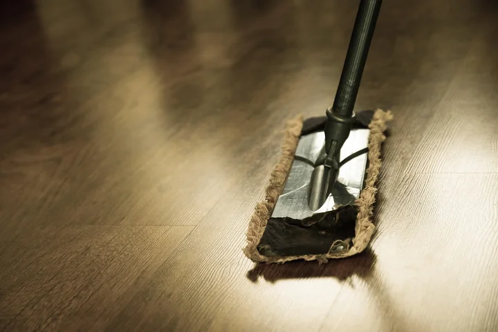 Close-up of a mop head cleaning a wooden floor