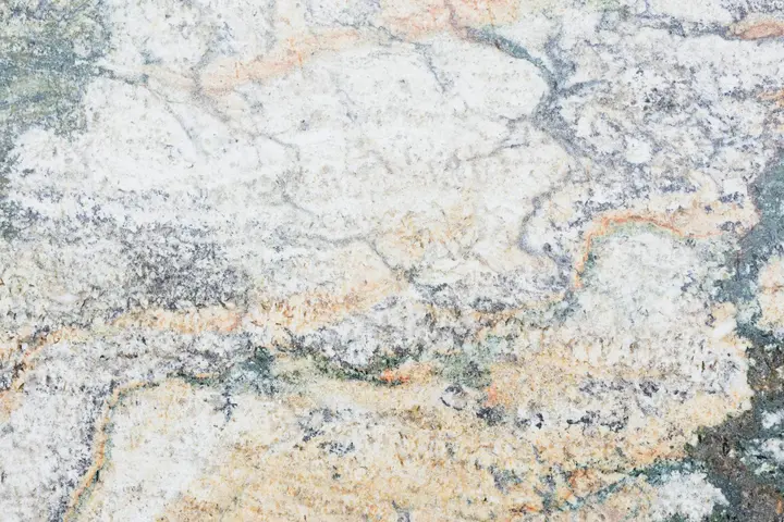 Close-up of a granite surface showing speckled grains and subtle veins.