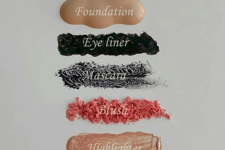 Close-up vertical swatches of makeup with labels: Foundation, Eye liner, Mascara, Blush, Highlighter.