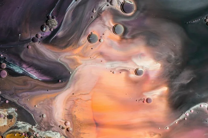 Abstract close-up of oil and grease swirls, symbolizing stubborn stains on silk fabrics.