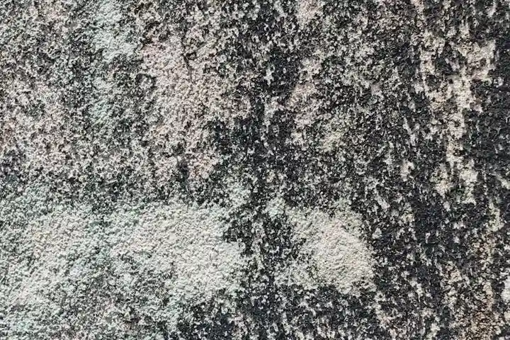 Close-up of a concrete surface with dark oil stains.
