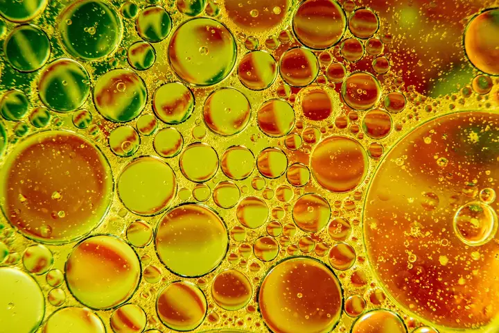 Close-up of colorful oil droplets on a surface, representing oil stains and the importance of confirming removal after cleaning