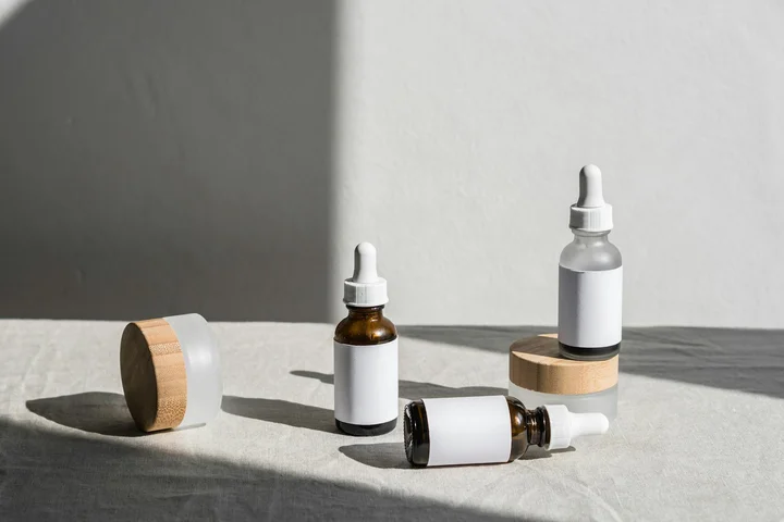 Assorted dropper bottles and containers on a light surface, representing advanced oil-stain removal tools