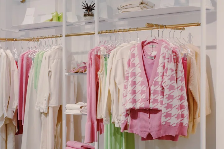 Rows of pastel-colored garments on racks in a boutique, illustrating a setting for stain-removal steps.