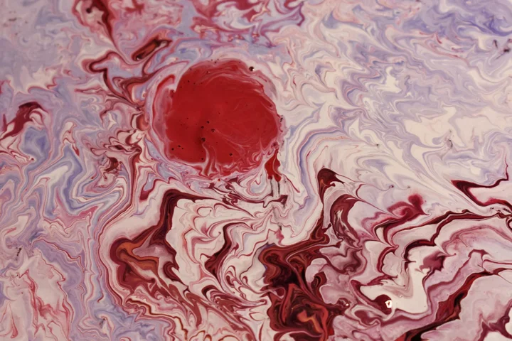 Abstract marbled pattern in pink and red tones