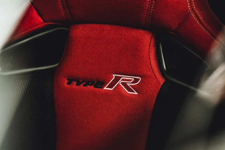 Close-up of a red sport car seat with the Type R emblem