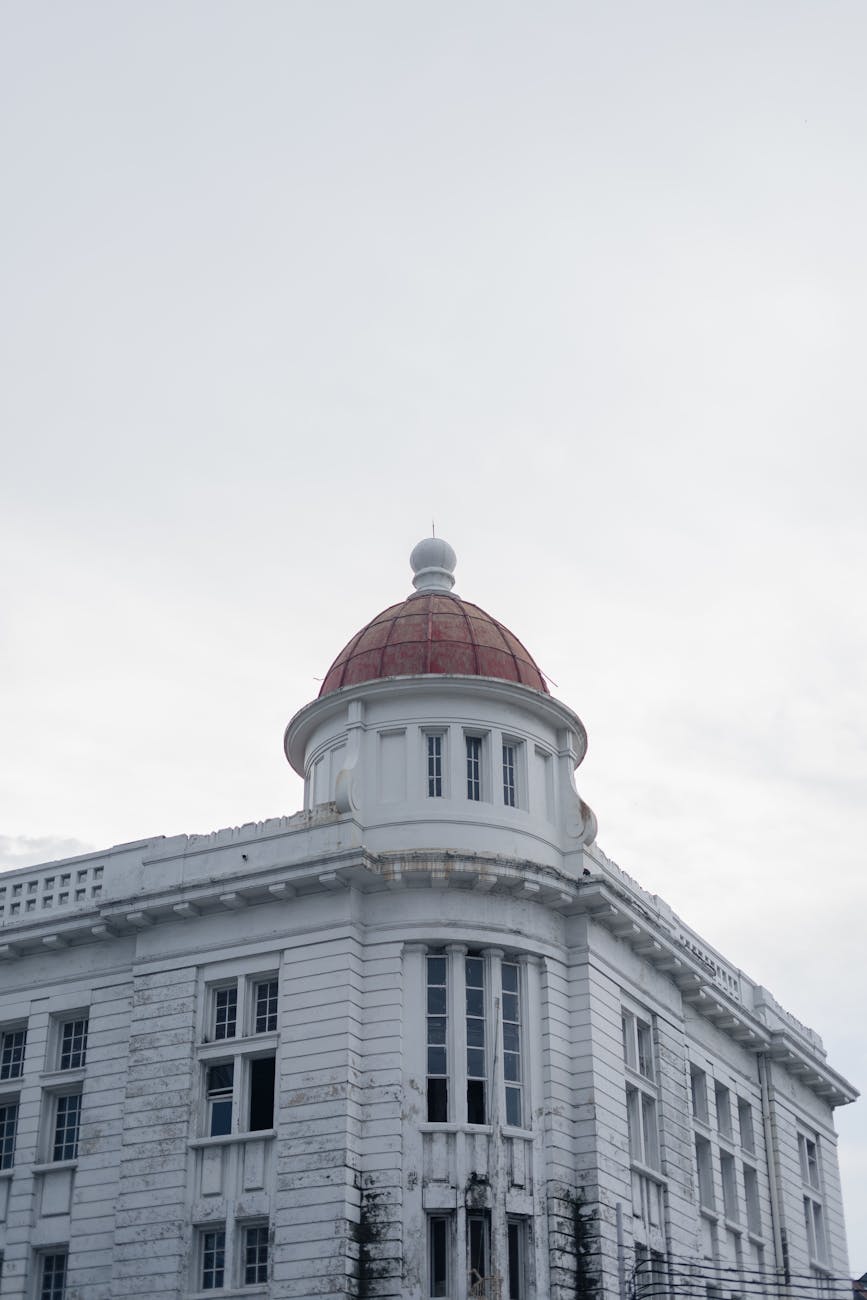 Close-up of gloved hands performing a spot test on a patterned fabric with a cotton swab.