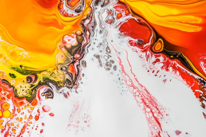 Abstract swirl of orange, yellow, red, and white paint representing rust stain challenges.