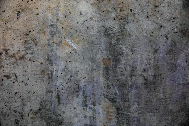 Close-up of a dirty, stained surface with marks and discoloration.