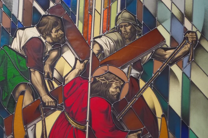 Colorful stained-glass panel depicting three artisans at work with tools, symbolizing early manual stain removal methods.