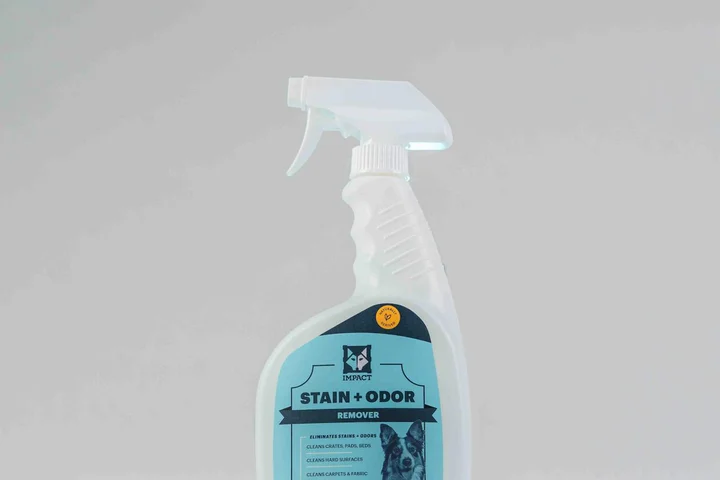 Spray bottle labeled 'Stain + Odor Remover' on a light gray background