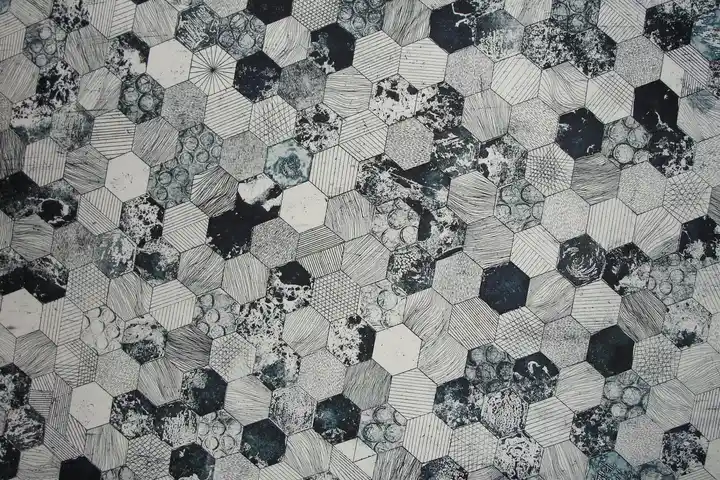 Close-up grayscale hexagonal tile pattern to symbolize testing stain-removal methods on different surfaces