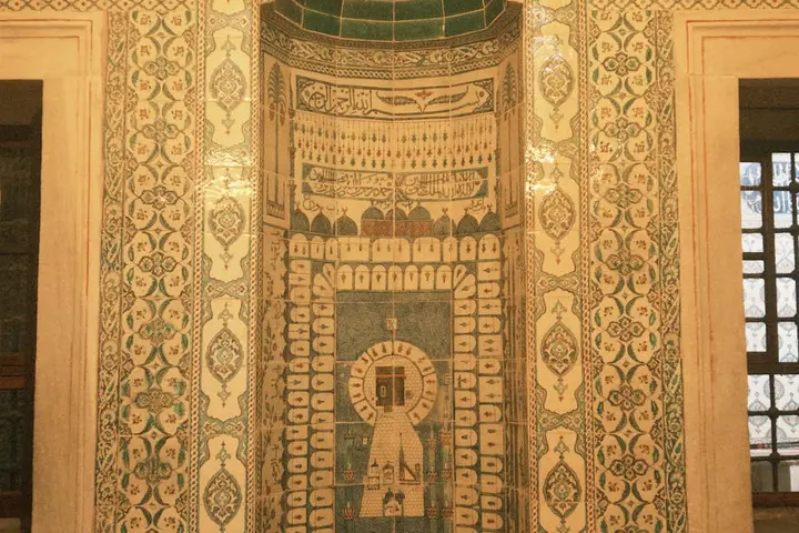 Decorative tile wall with intricate geometric patterns and a central mosaic design element