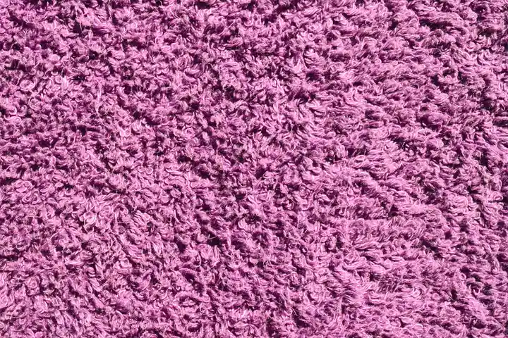 Close-up of a purple textured fabric surface.
