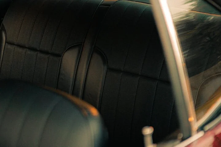 Dark car interior with fabric seats and panels, suggesting set-in stains and challenging cleaning