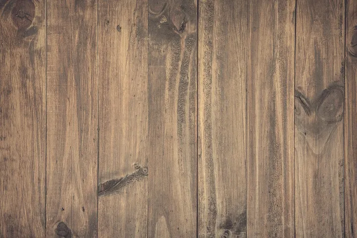Close-up view of brown wood laminate/hardwood floor planks with natural grain patterns