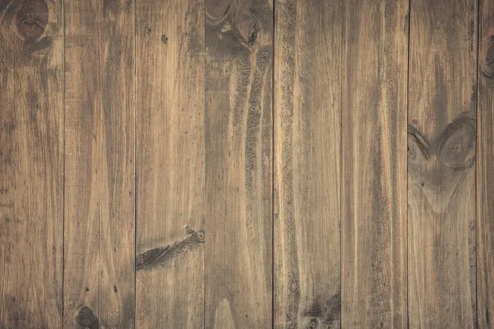 Close-up of brown wood-plank flooring with visible grain and knots