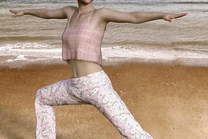 Person performing a yoga pose on a sandy beach